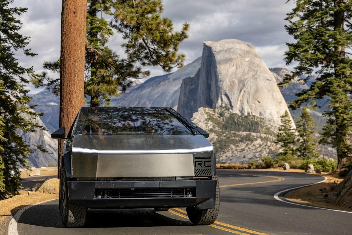 Tesla Cybertruck driving in Yosemite with Half Dome in the background